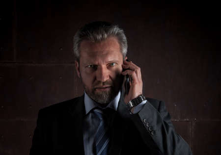 Portrait of a mature businessman on black backgroundの写真素材