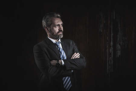 Portrait of a mature businessman on black backgroundの写真素材