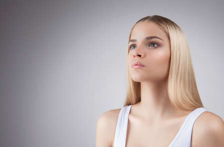 beauty face of blonde teenager girl isolated on white backgroundの写真素材