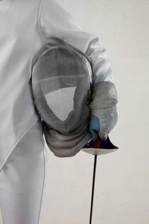 Female fencer hold the epee and rencer mask isolated on white backgroundの写真素材