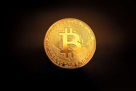Golden Bitcoin coin on a black background close upの写真素材