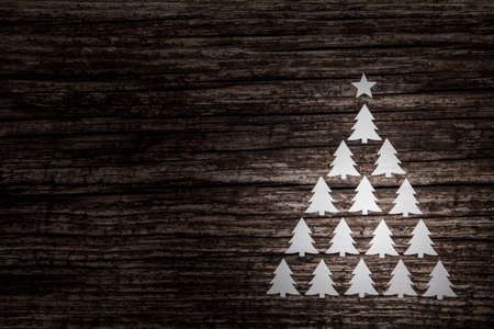 Christmas background. Three decorative fir on wooden background.の写真素材