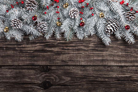 Christmas fir tree with decoration on dark wooden backgroundの写真素材