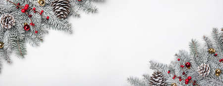 Christmas card. White background with snow fir tree and decoration. Top view with copy space for your textの写真素材