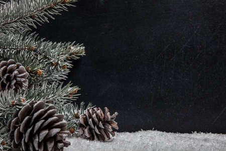 Christmas fir tree with decoration on black board backgroundの写真素材