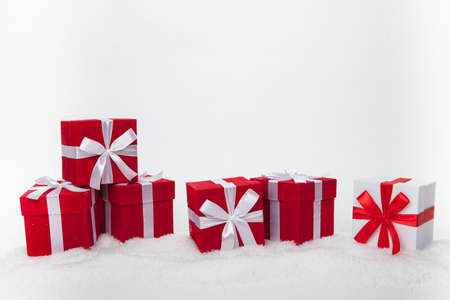 Christmas red and white gift boxes stay in line with copy space. Isolated on white