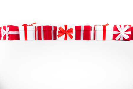 Christmas red and white gift boxes stay in line with copy space. Isolated on whiteの写真素材