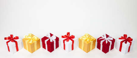 Christmas red and white and golden gift boxes stay in line with copy space. Isolated on white
