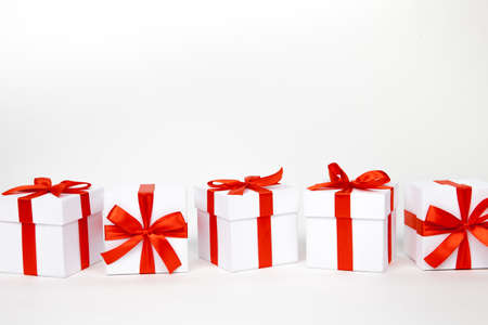 White boxes with a red satin ribbon bow Isolated on white background, Isolated