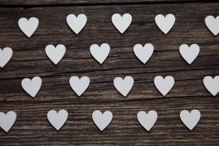 Valentines day card. A white hearts on old wooden background. Valentines pattern.の写真素材