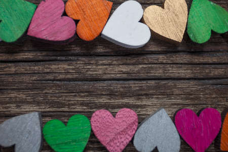 Valentines day card. A colorful hearts on a old wooden background. Copy space for text.の写真素材