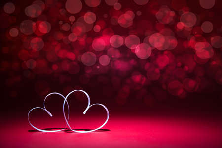 Two white Hearts on red background. Valentines day card.の写真素材
