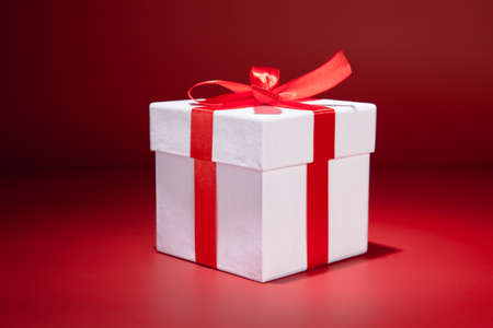 White gift box on red background. Copy spaseの写真素材