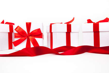 White boxes with a red satin ribbon bow Isolated on white background, Isolatedの写真素材