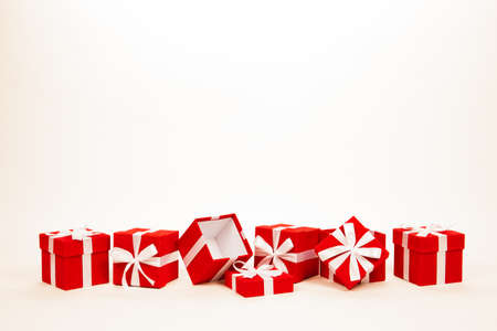Christmas red gift boxes stay in line with copy space. Isolated on whiteの写真素材