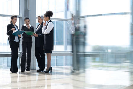 Group of Business woman stand near the window in office hallの写真素材