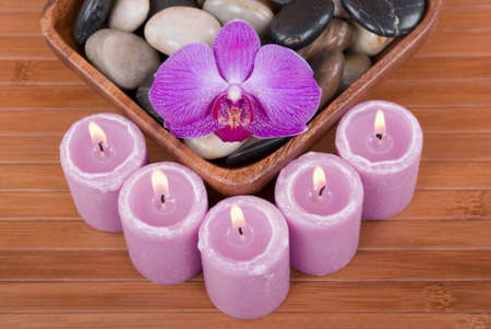 Orchid, pebbles, and candlesの写真素材