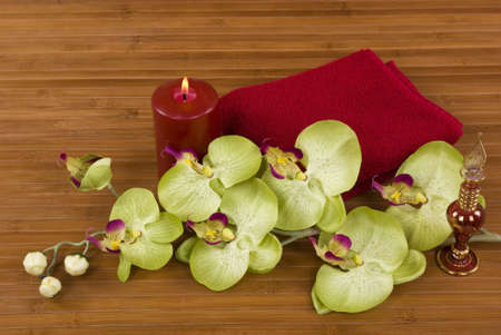 Orchid, towel, perfume bottle, and candleの写真素材