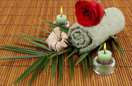 Rose, palm frond, towel, and candlesの写真素材