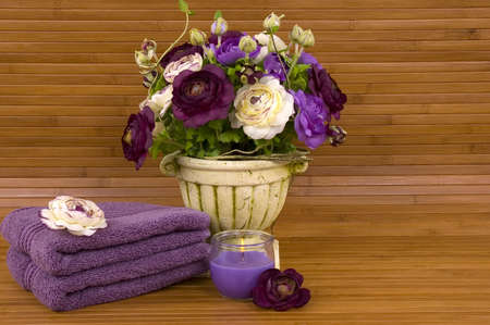 Colorful flowers, aromatic candle, and soft cotton towelsの写真素材