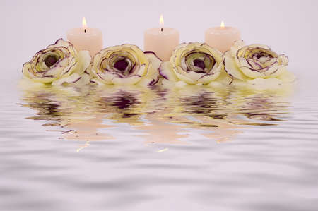 Flower, candles and their reflectionの写真素材