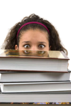 Student burried in homework (looking at the books with fear)の写真素材