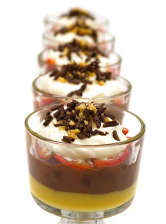 Trifle with chocolate pudding, vanilla pudding, strawberries, chocolate cake pieces, whip cream, walnuts and chocolate curlsの写真素材