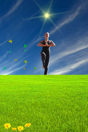 Young girl doing yoga on a fairy land sceneの写真素材