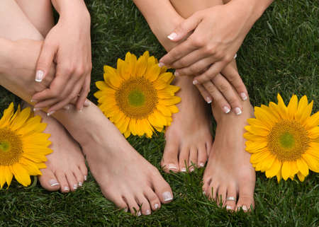 Pedicured feet on grassの写真素材