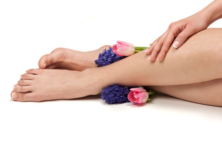 Pedicured feet, manicured hands and aromatic flowers in a spaの写真素材