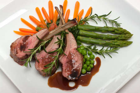 Gourmet lamb chop with vegetables, herbs and balsamic vinegar