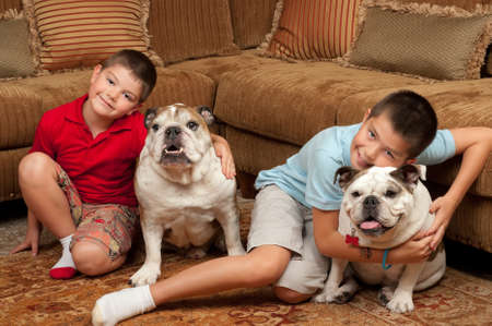 Brothers and their pet dogs in their homeの写真素材