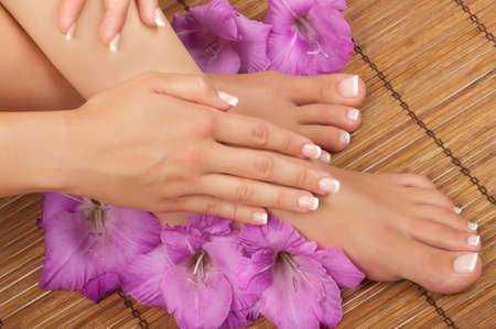 Pedicure and manicure spa with beautiful flowersの写真素材