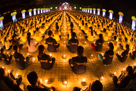 NINHBINH, VIETNAM - MAY 05   Vesak Day  Traditional buddhist monks are lighting candles for religious ceremonies at Bai Dinh temple on May 05, 2014 in Ninh Binh, Vietnamのeditorial素材