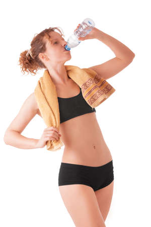 Young female drinking water isolated on white backgroundの写真素材