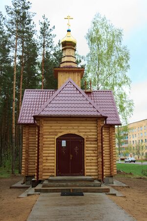 Small new wooden church on suburb of small townの写真素材