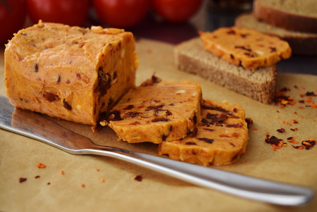 Homemade butter with sun-dried tomatoes for spreads on a backing paper. Healthy food conceptの写真素材