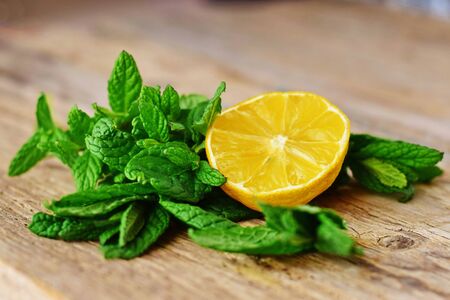 Lemon sliced and fresh mint on an abstract wooden surfaceの写真素材