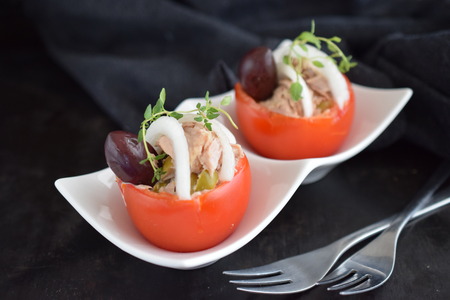 Tomato stuffed with tuna olives and onions.の写真素材