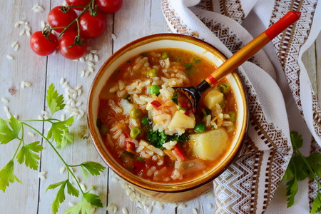 Vegetable soup with rice, tomato, potato, green peas, carrots and onions. Healthy eating conceptの写真素材