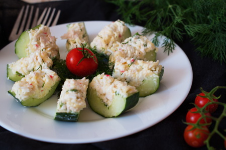 Appetizer from a fresh cucumber with crab meat, egg, cheese and dill. Christmas and New year coceptの写真素材