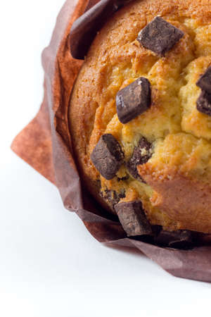 a delicious muffin with chocolate on top in front of a white backgroundの写真素材