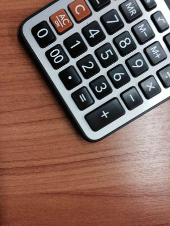 Calculator on the desk in the officeの素材