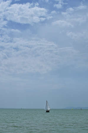 Small boat on lake Balaton, Hungary on a sunny summer day, verticalの写真素材