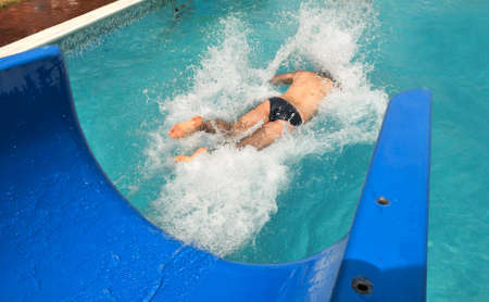 Man swimming in the pool with lots of splashesの写真素材