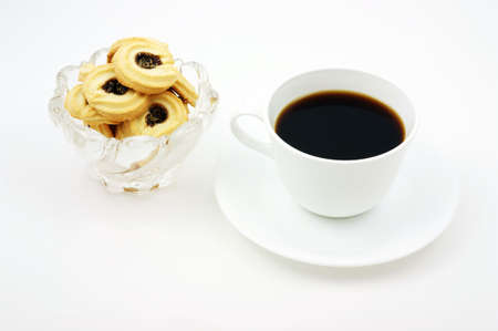 Coffee and delectable fruit filled biscuits for a break.の写真素材