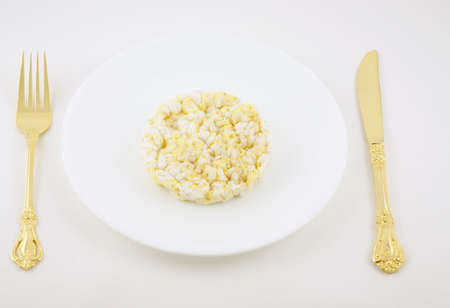 Rice cake on a plate with fork and knife. 