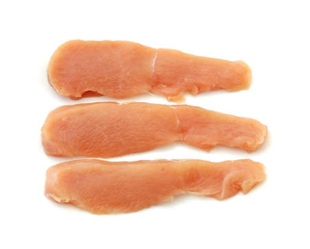Three pieces of fresh sliced chicken ready to season.の写真素材