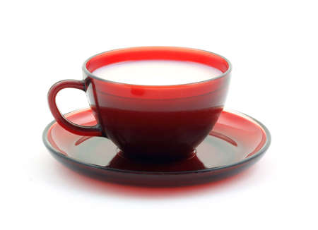 Red cup and saucer filled with skim milk. の写真素材