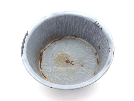 A very old rusty enameled gray tin pan. の写真素材